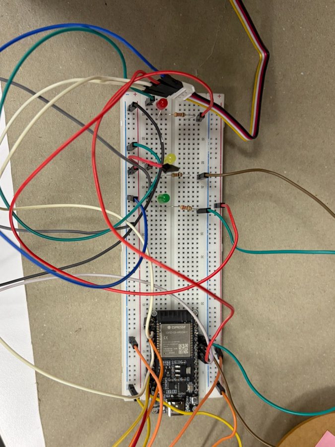 The ESP32-C6 board on a breadboard with red, yellow and green indicator LEDs and jumper wiring